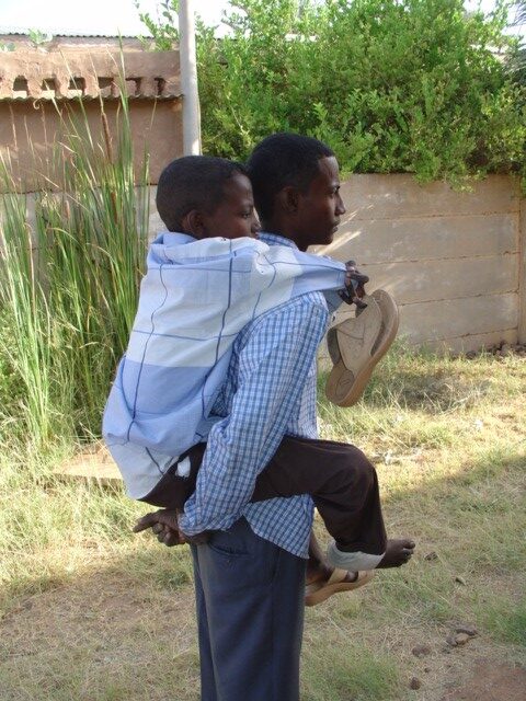 A patient arrived at the clinic, carried by his brother all the time.
