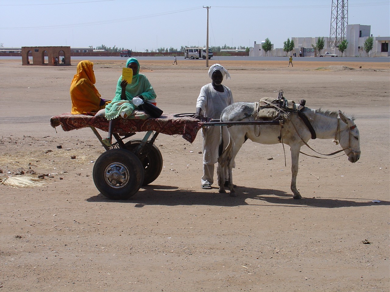 An amputee patient is arriving at the clinic with a donkey cart for follow-up.